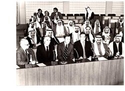 ["The image depicts Dewey Bartlett seated at the Federal National Assembly with Nather Omari, Clifford Hansen, Najmuddine Hamoodah, members of the Assembly with charge P. J. Griffen at the back and W. N. Howell, Jr. walking to the back"]
