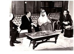 ["The image depicts Dewey Bartlett seated with Clifford Hansen, Paul Fannin, and H. E. Mana and Al Otaiba"]