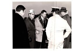 ["The image depicts Dewey Bartlett standing with Ed Pritchett, Lieutenant Colonel Morris, and Bill Bender"]