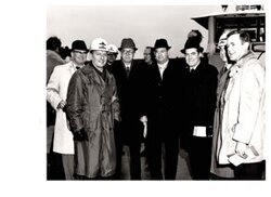 ["The image depicts Dewey Bartlett standing with Charles Gassaway, Colonel Pinkey, Colonel Ladd, Harold Scoggins, Ed Edmondson, and Brig. Gen. Parfitt"]