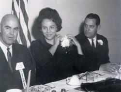 ["Fred R. Harris with Mrs. Iva Duggan of Tulsa who was the state president of classroom teachers and two unidentified men"]