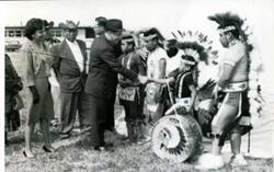 ["Fred R. Harris shakes hands with Lt Merkle after a flight in an U.S. Air Force jet Photo courtesy of the United States Air Force"]