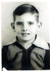 ["Fred R. Harris at his desk There are several unidentified people in his office"]