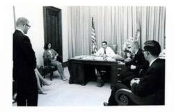 ["Fred R. Harris and Robert F Kennedy enjoy a laugh with two unidentified men July 1965"]