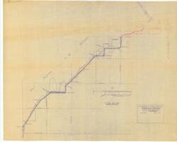 ["The document represents a plan item is an alignment section of a site plan for the proposed Farm-Market Road in Alfalfa County, Oklahoma. The portion of road to be constructed by the Army Corps of Engineers is hand-drawn and annotated in red pencil. The included typical section depicts the grading for drainage. Section, site plan (orthographic projection; diazotype, blueline print); 29 1/2 x 36 5/8 inches; Annotations (top, right corner; red, pencil) for Army Corps of Engineers road section."]