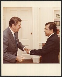 ["Written on post-it: w/Reagan in oval office to discuss AWACS sale to Saudi Arabia 10/20/1981. Stamp: Official Photograph The White House Washington."]