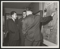 ["Caption: Sen. Inouye is briefed in the \"Big Lift\" operations center at Rhein-Main A/F Base at Frankfurt Germany following the Senator's arrival from Bergstrom A/F Base Texas aboard a troop carrier with participating troops of the 2nd Armored Division."]