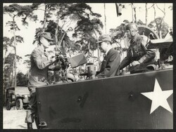 ["Caption: \"This is how it works\" -- 1st Lt Roger N Murai, 2/87 Adjutant, a native of Hawaii, explains the working of the new M-60 machine gun to Senator Inouye, who wears the official 2/87 fatigue cap. At right is Sgt Flabel H. Warr, 2/87 Scout Section Lea"]