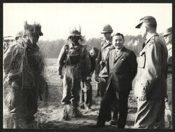 ["Caption: \"A fine demonstration\" -- Senator Inouye and Lt Col Frederick A. Smith, Jr. exchange remarks while studying camouflage of 2/87's Company C troopers following their company attack demonstration. From left is FCC Joseph W. Chinn, Rifleman, S/Sgt Cu"]