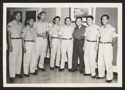 ["Caption: Left to right, A/1C Neal T. Okamoto, A/3C Henry Y. Tanaka, A/2C Gary Wong, A/1C Albert M. Ishikaiwa, A/2C Ronald W. Carbonell, Congressman Daniel Inouye, A/2C Darryl Ho and A/3C William K. Ikaika."]
