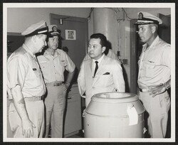 ["Information in title from back of photo. Caption: Left to right: LCDR R. D. Robertson (Repair Officer), CAPT P. P. Cole (Chief of Staff, ComSubPac), CAPT W. A. Grossetta (C.O. Subase). Stamp: Photo Lab U.S. Naval Submarine Base Pearl Harbor, Hawaii."]