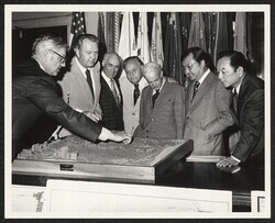 ["Caption: Examining the scale model of the planned development of the Punchbowl are: Senator Daniel Inouye (right), Richard L. Roudebush, Administrator of Veterans Affairs (center), John Mahan, Director of National Cemetery System (left)"]