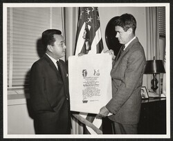 ["Caption: Senator Daniel K. Inouye (Hawaii) presenting scroll, shoulder patch and a crest of the 100 Bn 442nd Inf to Honorable Cyrus R. Vance, Secretary of the Army, in a ceremony held at the Pentagon, Washington, D.C. Photo by: SFC K. C. Uchima, U.S. Army"]