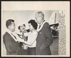 ["Caption: WASHINGTON, Aug. 9--HAWAIIAN WELCOME--Daniel K. Inouye, Hawaii's new Democratic Representative-elect, is welcomed at nearby Friendship Airport today by Sue Shimokawa, who places a lei around his neck. Democratic National Chairman Paul Butler, rig"]