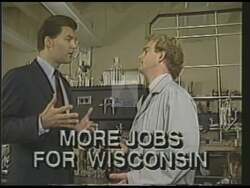 ["In the 1988 political ad for Kevin J. Hermening, he addresses audiences from a podium, emphasizing on job creation and economic growth specifically in northern Wisconsin. Hermening presents himself as dedicated to local concerns, focusing on infrastructure and investment to stimulate regional development. His speech is bolstered by the presence of supportive constituents."]