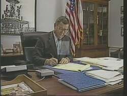 ["In his 1988 campaign ad, Democratic candidate Tom Luken showcases his commitment to public safety. The ad features multiple scenes of Luken passionately advocating in Congress for railway safety laws, especially against drug impairment. His leadership is highlighted as he celebrates legislative victories, surrounded by supporters and media, emphasizing his success in enhancing train safety regulations."]