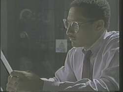 ["In his 1988 campaign ad, Democratic candidate Mike Espy is portrayed as a dedicated and strong leader, passionately advocating for Mississippi's welfare and progress. The scenes consistently depict him as confident and resolute, engaging with diverse constituents, and emphasizing his commitment to both social and economic issues. Flanked by American flags, his dynamic addresses highlight his leadership ambition for Mississippi's development."]