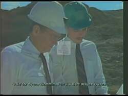 ["In the 1990 campaign ad, Democratic candidate Douglas Wayne Owens emphasizes his commitment to community improvement in Salt Lake County, contrasting his record with opponent Genevieve Atwood, who is depicted as cutting essential services funding. Owens appears passionate and determined, addressing crowds and advocating for local enhancements while highlighting legislative differences with Atwood."]