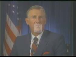 ["In his 1990 presidential campaign TV ad, Republican candidate Dan Burton stands firm on fiscal responsibility, consistently criticizing excessive congressional spending and opposing tax increases in various settings. He advocates for reduced government spending, staunchly maintaining his stance against tax hikes in each scene, delivering his message with a serious demeanor."]