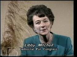 ["In her 1990 presidential campaign ad, Democratic candidate Elizabeth H. (Libby) Mitchell powerfully advocates for a balanced approach to governance. Scenes from the ad showcase her speaking confidently on balancing economic prosperity with strong national defense, all set against backdrops that evoke American patriotism, such as flags and a campaign banner emphasizing her commitment to both areas."]