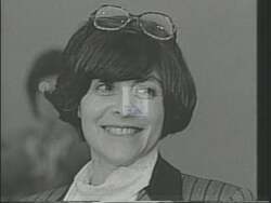 ["In the 1994 political TV ad for Democratic candidate Charlotte Koskoff, visuals of dilapidated factories and deserted industrial streets starkly symbolize economic decline and job loss. Koskoff speaks to hopeful workers about change, amidst scenes of desolation and neglect. Campaign signs urge support while faded American flags underscore the urgency for revival and economic attention."]