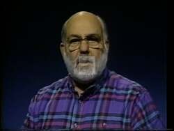 ["In the 1994 Libertarian presidential campaign ad, Barrie Konicov passionately advocates for strict adherence to the U.S. Constitution, emphasizing the need for monetary reform. The scenes consistently show him at podiums, emphasizing constitutional compliance in financial governance and critiquing the Federal Reserve's policies, underscored by American flags and campaign banners."]