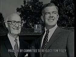 ["The 1994 political ad for Democratic candidate Thomas S. Foley showcases his authoritative congressional leadership, emphasizing his dedication to agricultural, public safety, economic, and legal reforms. Through engaging speeches across various settings, including Congress and public platforms, Foley demonstrates his commitment to integrity, leadership, and legislative achievements, surrounded by symbols of American patriotism and backed by supportive crowds. The ad positions him as a stern yet hopeful advocate focused on impactful national and local reforms."]