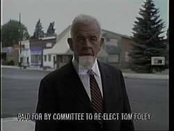 ["In his 1994 presidential campaign ad, Democratic candidate Tom Foley is shown passionately speaking at various podiums, advocating for strong national policies, robust reforms, and enhanced law enforcement. He emphasizes the importance of responsibility and rights, repeatedly calling for the strengthening of America through diligent work-focused reforms and a commitment to law and order."]