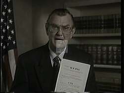 ["In Harold Lee Volkmer's 1994 presidential campaign ad, he discusses the need for welfare reform, evidenced by various scenes with statistics, graphs, and American flags. He speaks from podiums and against backdrops of concerned families and distressed environments, advocating a shift from dependency to employment, emphasizing the positive impacts of his welfare reform proposals."]