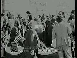 ["In Harold Lee Volkmer's 1994 campaign ad, scenes depict his opponent Kenny Holzhoff repeatedly signing contracts that harm public interests by favoring the wealthy with tax cuts and increased defense spending, all while slashing funding for crucial social and educational programs within the 9th District. The ad portrays Holzhoff as prioritizing special interests over district welfare."]