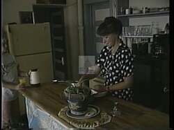 ["In a 1994 political TV ad, Sandy Cummins, owner of a bed and breakfast in Lamont, Wyoming, expresses concerns over community neglect, symbolized by a missing highway sign. Republican candidate Rob Wallace is portrayed as a supportive figure fighting government neglect, highlighting his commitment to rural communities and local businesses."]