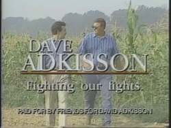 ["In the 1994 political TV ad, Ron Lewis and Newt Gingrich are seen campaigning and discussing policy priorities, with multiple scenes underscoring their support for Democratic presidential candidate Dave Adkisson. The ad highlights Adkisson's endorsement by his hometown paper and his commitment to protect local interests, despite Gingrich's differing stance on tobacco price supports."]