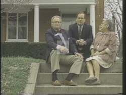 ["In the 1994 political TV ad for Democratic candidate Michael Delavan Ward, the scenes feature a middle-aged white man in a suit, speaking earnestly to the camera from a variety of simple, unadorned settings. He communicates his political goals, personal backstory, and promises tough legislation and reforms. The recurring presence of American flags emphasizes his patriotic appeal."]