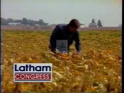 ["In his 1994 campaign TV ad, Tom Latham emphasizes his deep connection to Iowa's agricultural roots and family values. Standing confidently in various fields, he appeals to voters by embodying the state's work ethic and dedication. His casual farmer attire and earnest tone reinforce his message of local pride and commitment."]
