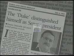 ["In the 1994 presidential campaign ad, Democratic candidate Duke DeTremble confidently speaks at various rallies, promoting strong leadership and community values. Scenes depict him addressing enthusiastic crowds across Maine, bolstered by American and state flags, emphasizing his commitment with a solid, determined demeanor at the podium."]