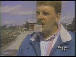 ["In a 1994 political TV ad, railway engineer Larry LaRock discusses the insecurity in his job due to company acquisitions. Expressing distress and concern while standing by train tracks in rural Vermont, LaRock endorses Bernie Sanders, praising his opposition to unjust employee layoffs and corporate actions, reflecting Sanders' commitment to supporting workers."]