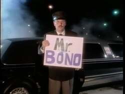 ["The 1994 Democratic campaign ad targets Sonny Bono, emphasizing his luxurious, taxpayer-funded lifestyle as he repeatedly exits a limousine in various scenes. Each segment critiques his use of lavish taxpayer-funded travel and hints at the excesses of his congressional aspirations, suggesting a misalignment with taxpayer interests."]