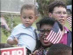 ["In the 1994 campaign ad for Democratic candidate Cleo Fields, the politician is seen passionately addressing a diverse and supportive crowd, emphasizing his leadership qualities and empathy for community issues. Fields advocates for the welfare of his constituents with scenes underscoring his commitment to family, health, and community well-being."]
