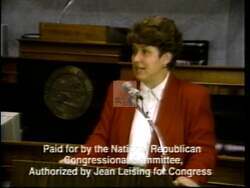 ["In her 1996 campaign ad, Republican candidate Jean Leising emphatically promotes her anti-tax stance, strict welfare and sentencing policies, and strong conservative values. Addressing large, supportive crowds with the American flag frequently visible, she vows to bring decisive change to Washington, conveying a determined and patriotic image."]