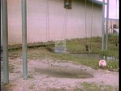 ["In the 1996 political TV ad for Republican Joe Rogers, the video opens with Diana DeGette appearing concerned or thoughtful, possibly during a public speaking event. This imagines DeGette in a moment of contemplation or debate, suggesting serious consideration of issues at hand. The scene sets a reflective tone for the ad."]