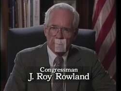 ["In his 1992 campaign ad, Congressman James Roy Rowland highlights his non-partisan, balanced legislative philosophy. Through scenes of him addressing the camera, speaking at press conferences, and engaging with audiences, Roland presents himself as a pragmatic, moderate leader. He emphasizes his commitment to bipartisan governance, illustrated by visuals of him at the podium with an American flag and campaign banners, projecting a sincere, professional demeanor."]