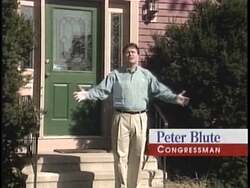 ["The 1996 political TV ad for Republican Party candidate Peter I. Blute showcases him confidently dismissing attacks from opponents, focusing on his commitment to representing local community interests rather than succumbing to liberal agendas. The ad portrays Blute as a resilient, dedicated local congressman, standing firm amidst a backdrop of mud-slinging, with scenes reinforcing his defiance and loyalty to his constituents."]