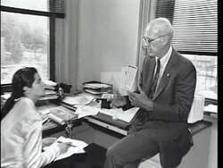 ["In the 1996 political TV ad for John Walter Olver, scenes depict him confronting and debating Republican leaders like Newt Gingrich. Firmly defending key social and environmental programs, Olver stands resolute against legislative cuts proposed by Republicans. He is portrayed as a determined protector of public services and resilience in the face of opposition."]