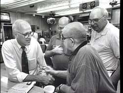 ["In the 1996 political TV ad, Democratic Congressman John Walter Olver is depicted actively engaging with his Massachusetts constituents. Through various scenes, the ad emphasizes his dedication to family, community improvement, local jobs, and healthcare. Olver is shown speaking passionately at podiums and interacting directly with workers on factory floors, highlighting his commitment to addressing and advocating for the community and state needs."]