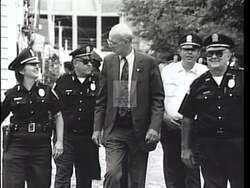 ["In the 1996 presidential campaign ad, Democratic candidate John Walter Olver emphasizes his commitment to local communities. Featuring scenes of Olver engaging with constituents, addressing crowds, and working in his office, the ad highlights his dedication to family support initiatives, educational enhancements, healthcare access, and economic growth, positioning him as a dedicated servant to working families."]