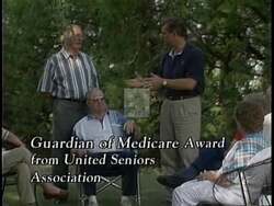 ["In a 1996 campaign ad, Republican Todd Tiahrt earnestly addresses the audience from a podium, with an American flag backdrop. He promotes his accomplishments in tax cuts and budget reductions, emphasizing fiscal responsibility. Tiahrt seeks reelection by stressing his commitment to these principles and asking for votes with gratitude."]
