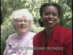 ["In the 1996 presidential campaign ad, Democratic candidate Cynthia McKinney passionately advocates for Georgia landowners. She stands confidently at podiums in Washington and addresses Congress against corporate and mining abuses, depicting her as a dedicated leader standing up for community rights amidst a supportive and captivated audience."]