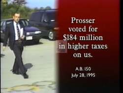 ["In the 1996 campaign ad, Democratic Party candidate Jay Johnson is portrayed positively, focusing on his supportive policies for working families. His opponent, Dave Prosser, is depicted unfavorably across various scenes, criticized for his political decisions, including voting for significant tax increases, with visuals implying Prosser's mismanagement of public interests."]