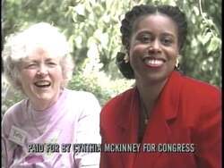 ["In her 1996 campaign ad, Cynthia McKinney is depicted as a dedicated community advocate, directly contrasting with her opponent John Mitnick, portrayed in connection with Newt Gingrich's unfavorable policies. Scenes emphasize McKinney's commitment to community safety, fair wages, and Medicare protection, while painting Mitnick negatively. McKinney's stance is shown as positive and community-focused throughout the ad."]