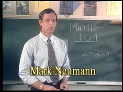 ["In Mark Neumann's 1996 political ad, the Republican candidate and former math teacher expresses visible frustration at a podium, debunking opponents��������� false claims about budget cuts. He emphasizes their poor math skills and misunderstandings, advocating for basic math education to rectify misrepresentations of fiscal policy and spending debates."]